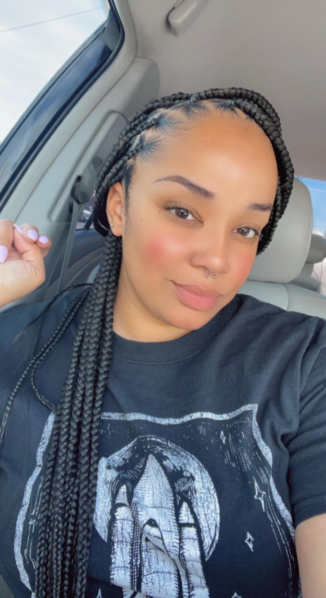 Client with medium knotless box braids styled long over her shoulder